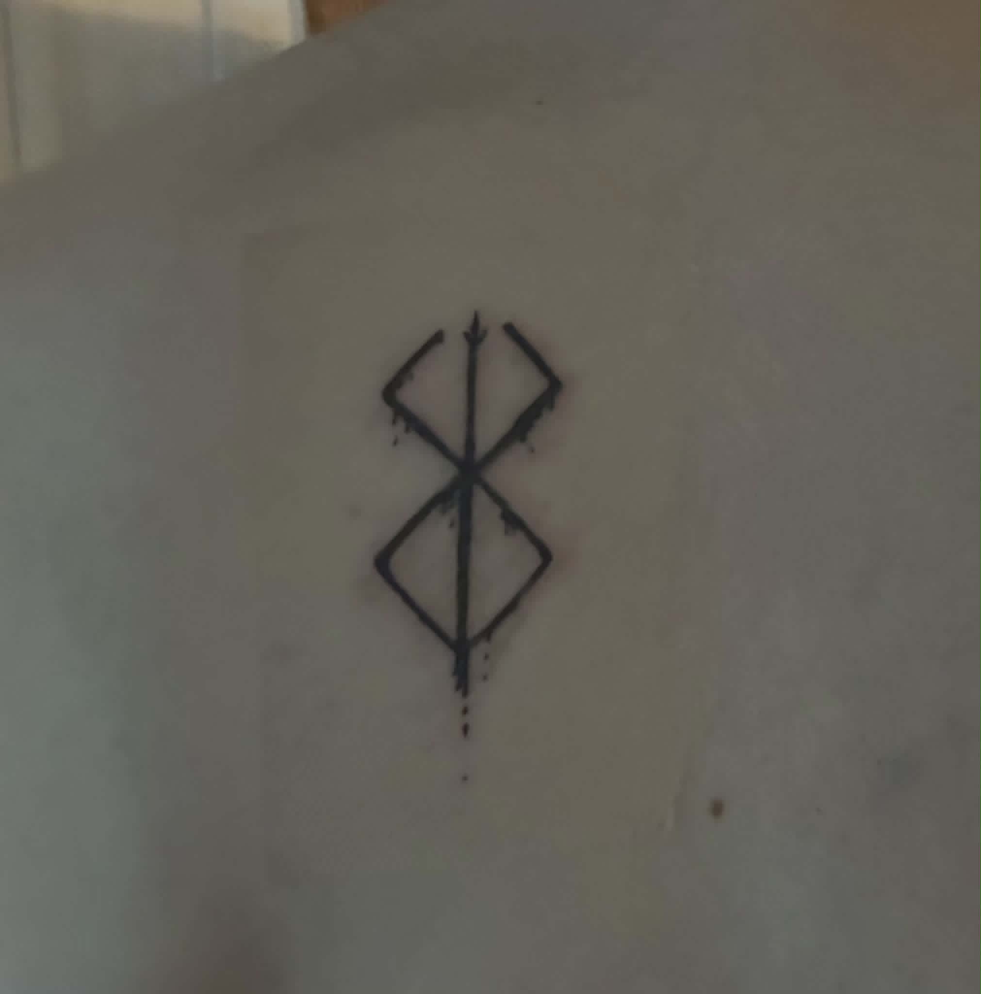 Berserk brand of sacrifice tattoo on back
